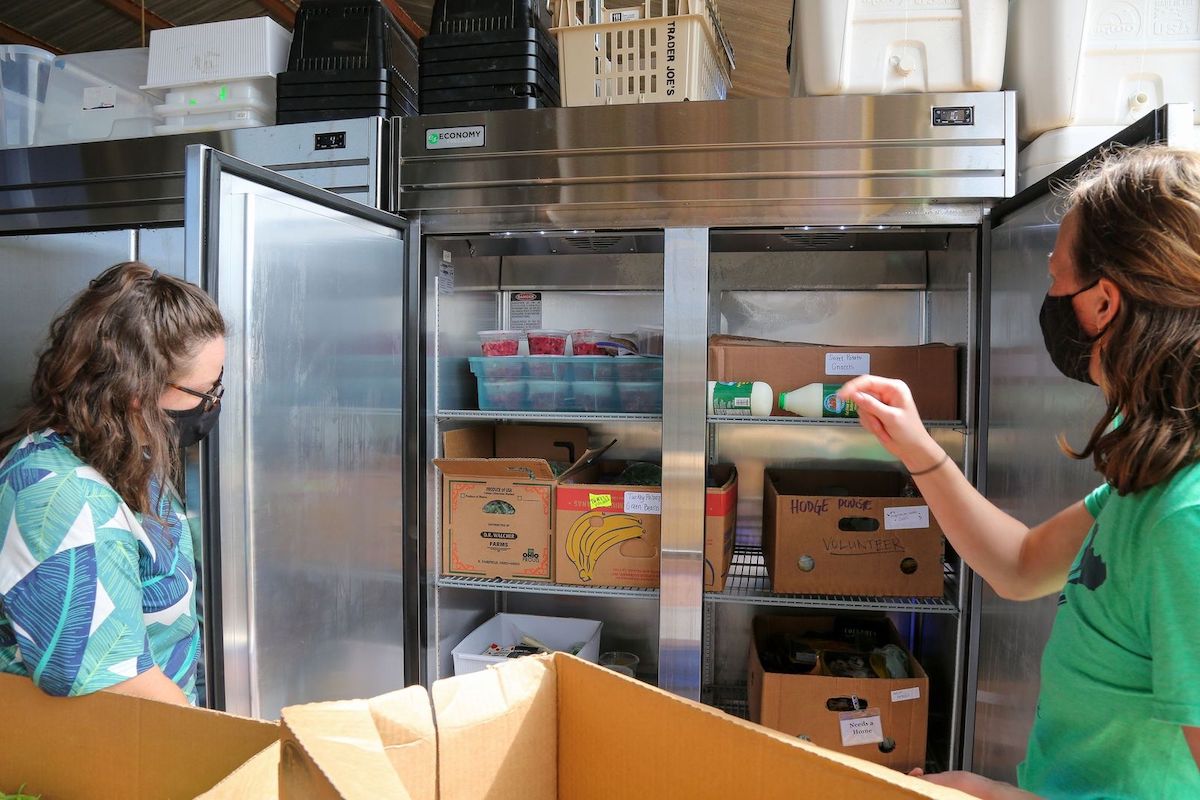 workers stocking campus kitchen freezer